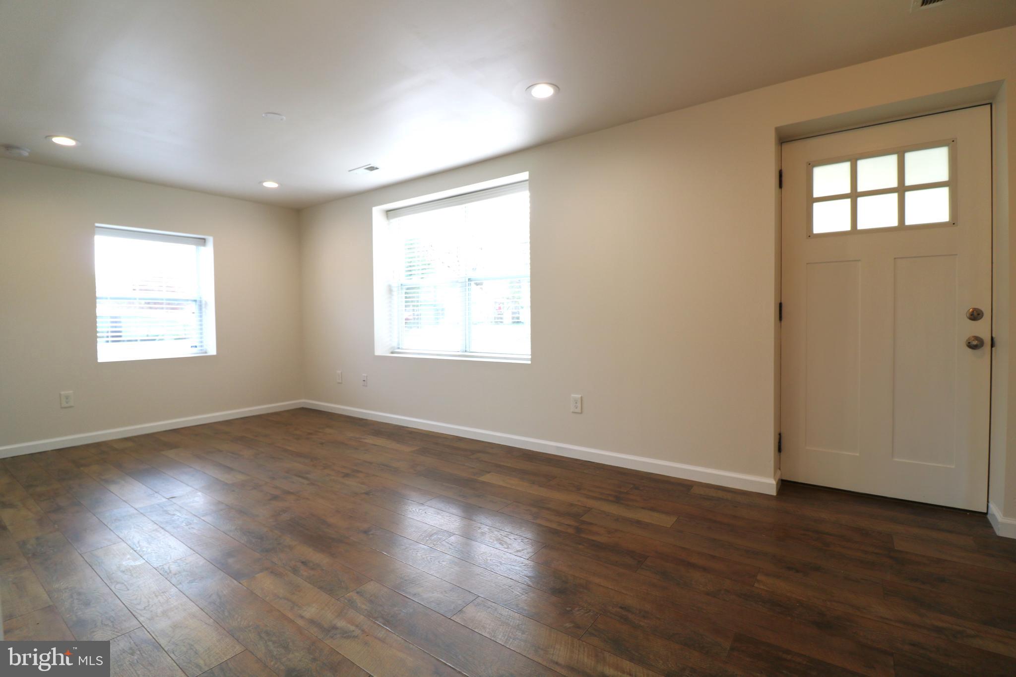 143 Mitscher Road Dover, DE 19901 - Photo 18 of 25 an empty room with wooden floor and windows