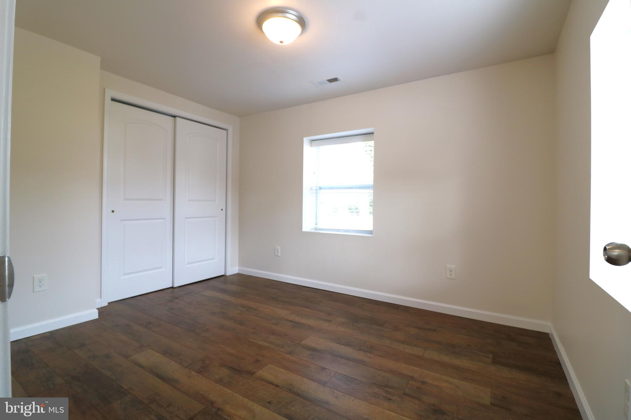 143 Mitscher Road Dover, DE 19901 - Photo 19 of 25 an empty room with wooden floor and windows
