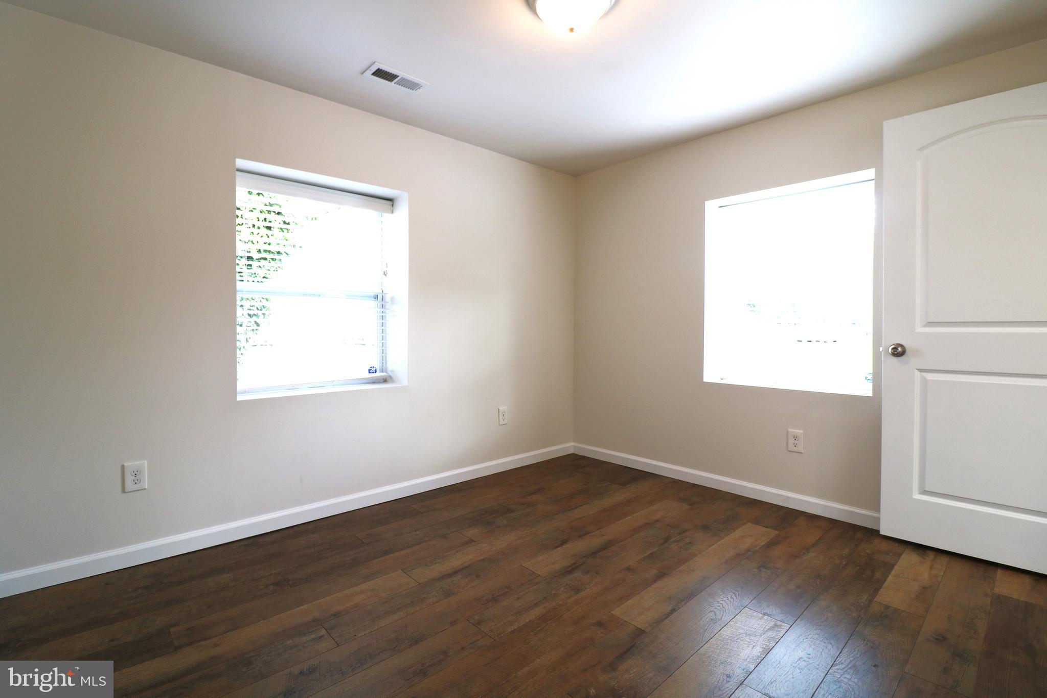 143 Mitscher Road Dover, DE 19901 - Photo 20 of 25 an empty room with wooden floor and windows