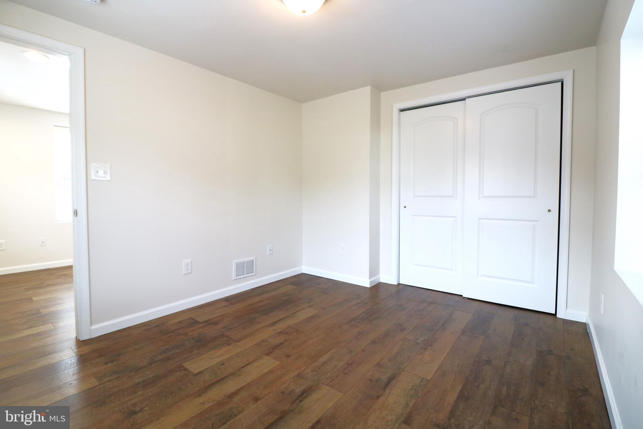 143 Mitscher Road Dover, DE 19901 - Photo 21 of 25 an empty room with wooden floor and closet