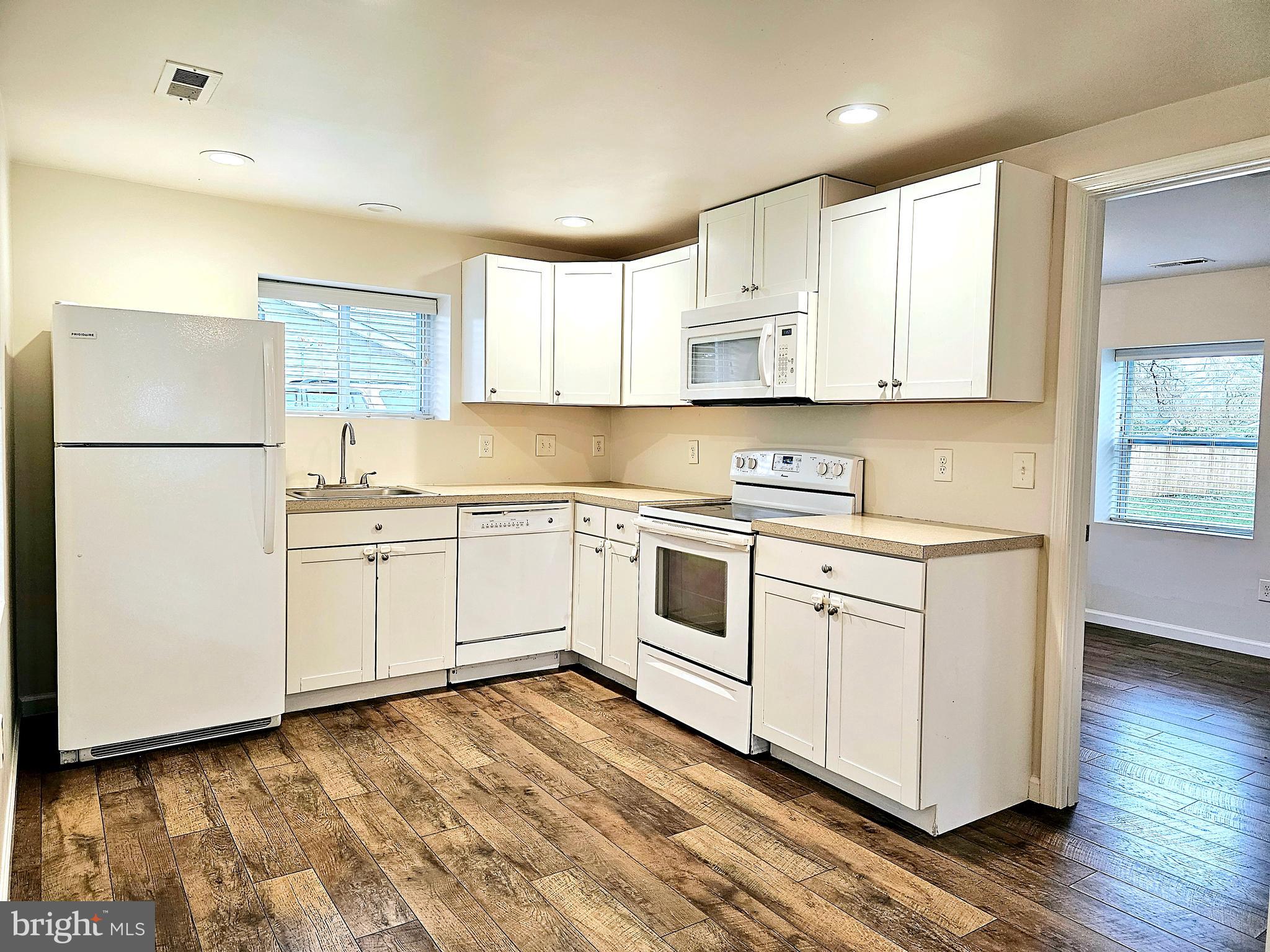 143 Mitscher Road Dover, DE 19901 - Photo 6 of 25 a kitchen with granite countertop white cabinets and white appliances
