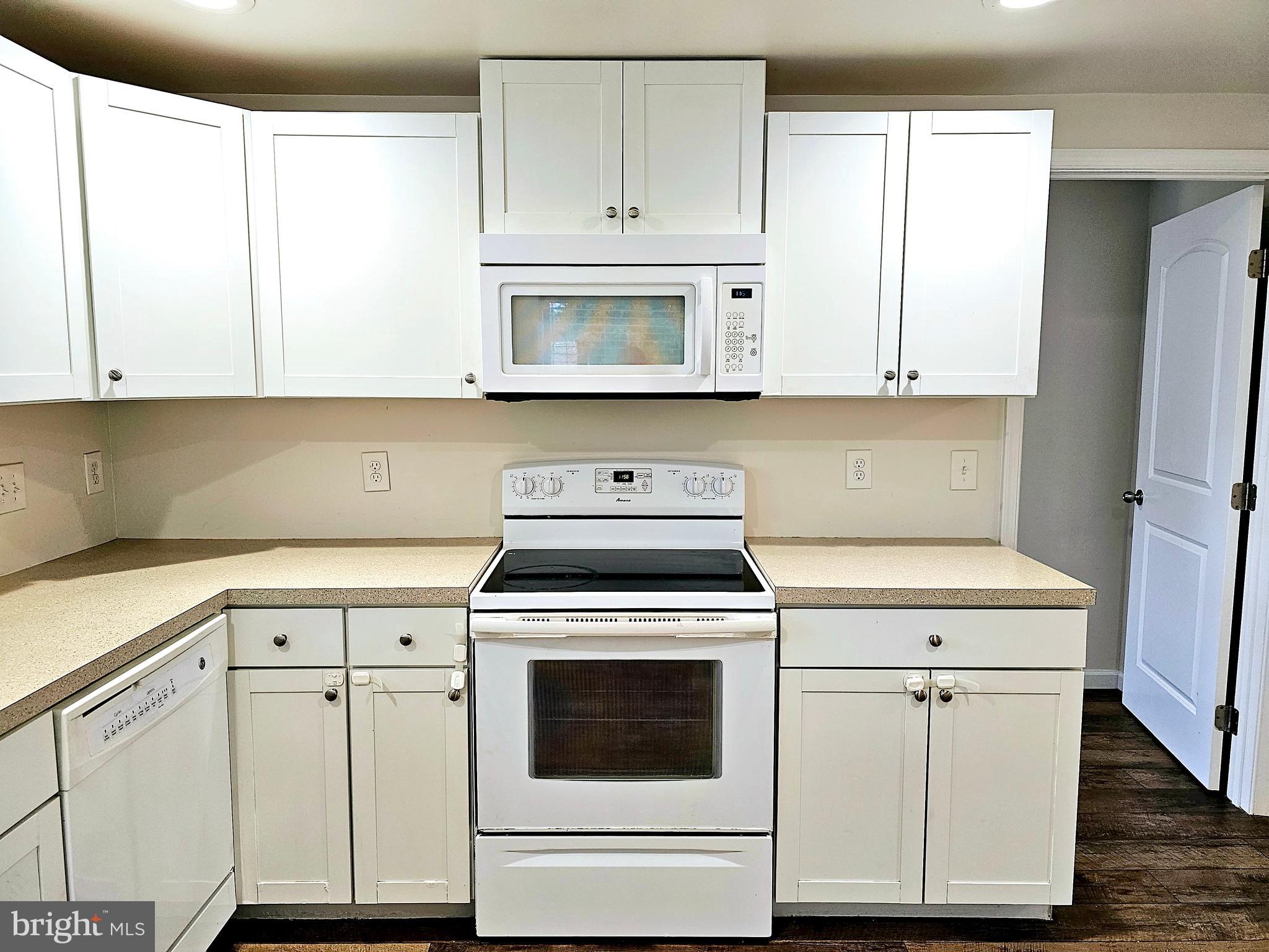 143 Mitscher Road Dover, DE 19901 - Photo 7 of 25 a kitchen with white cabinets and white appliances