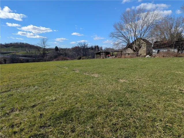 a view of a big yard with a lake view
