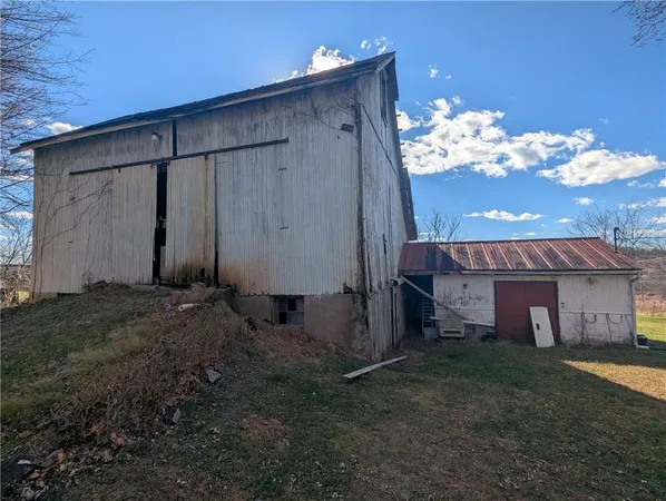 a view of a house with a yard covered in snow