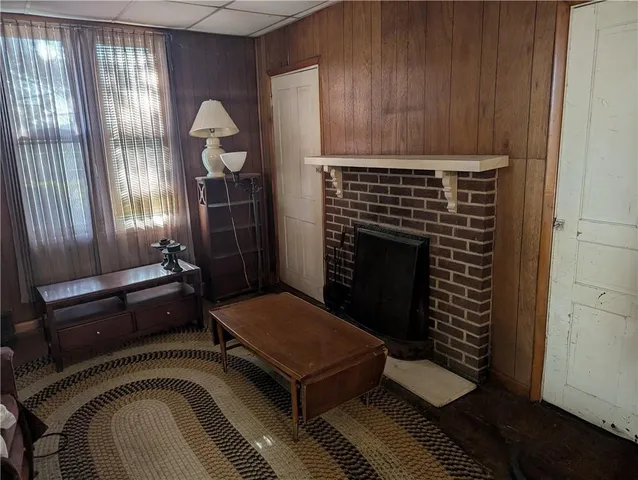 a room with a fireplace and wooden floor