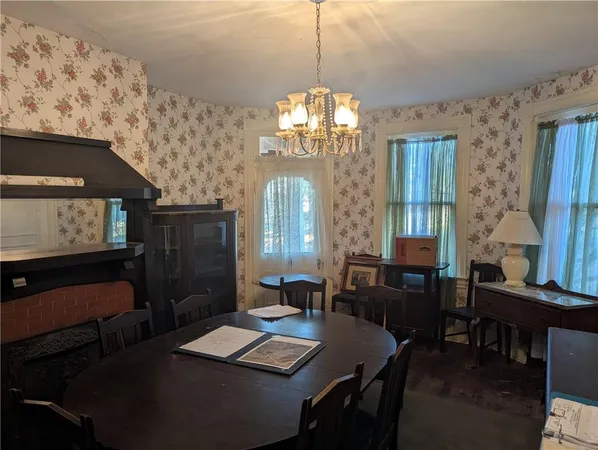 a view of a dining room with furniture and chandelier