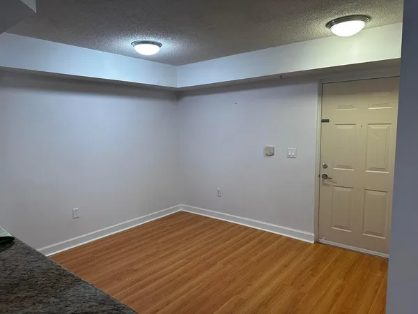 an empty room with wooden floor and closet