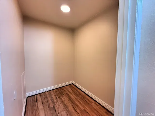 a view of hallway with wooden floor