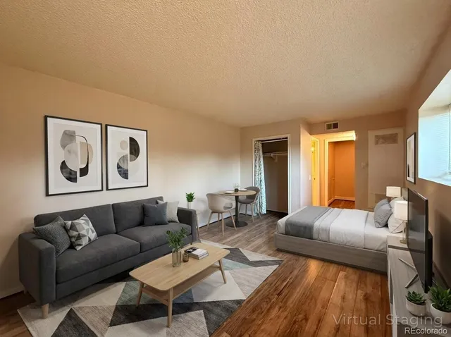 a living room with furniture and wooden floor