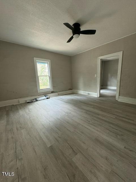 1615 Poole Road Raleigh, NC 27610 - Photo 12 of 14 an empty room with wooden floor and windows