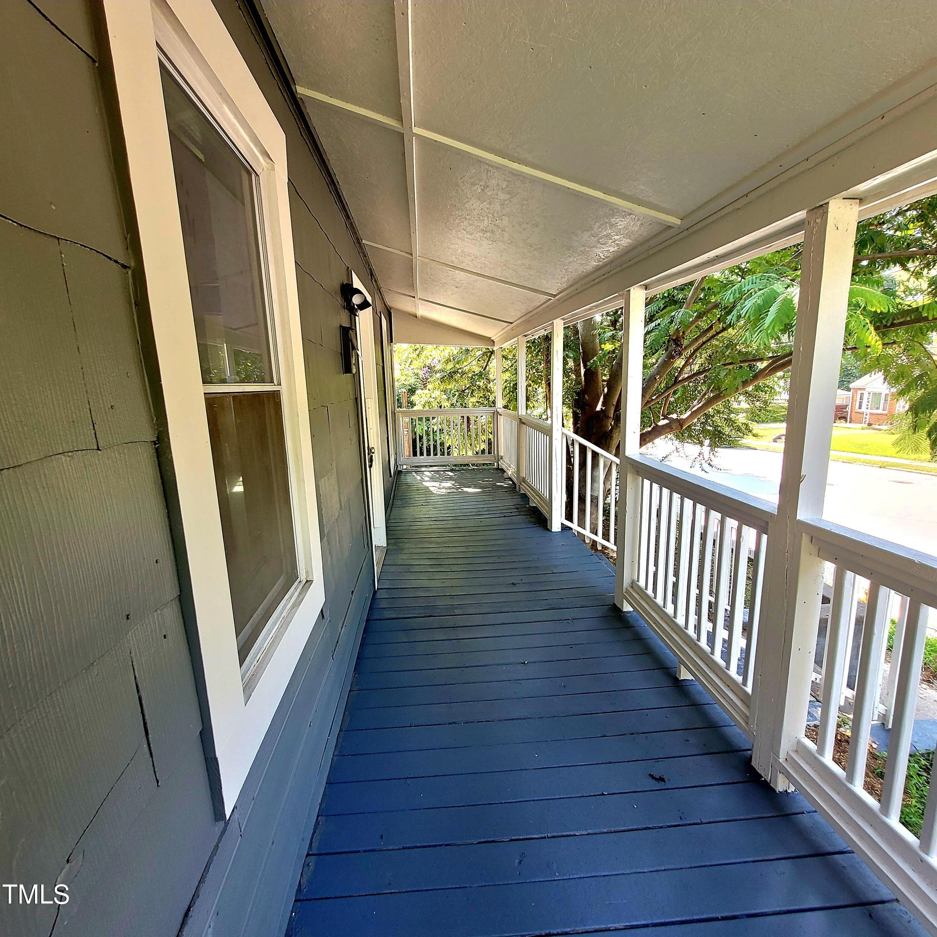1615 Poole Road Raleigh, NC 27610 - Photo 5 of 14 a view of a hallway with wooden floor and door
