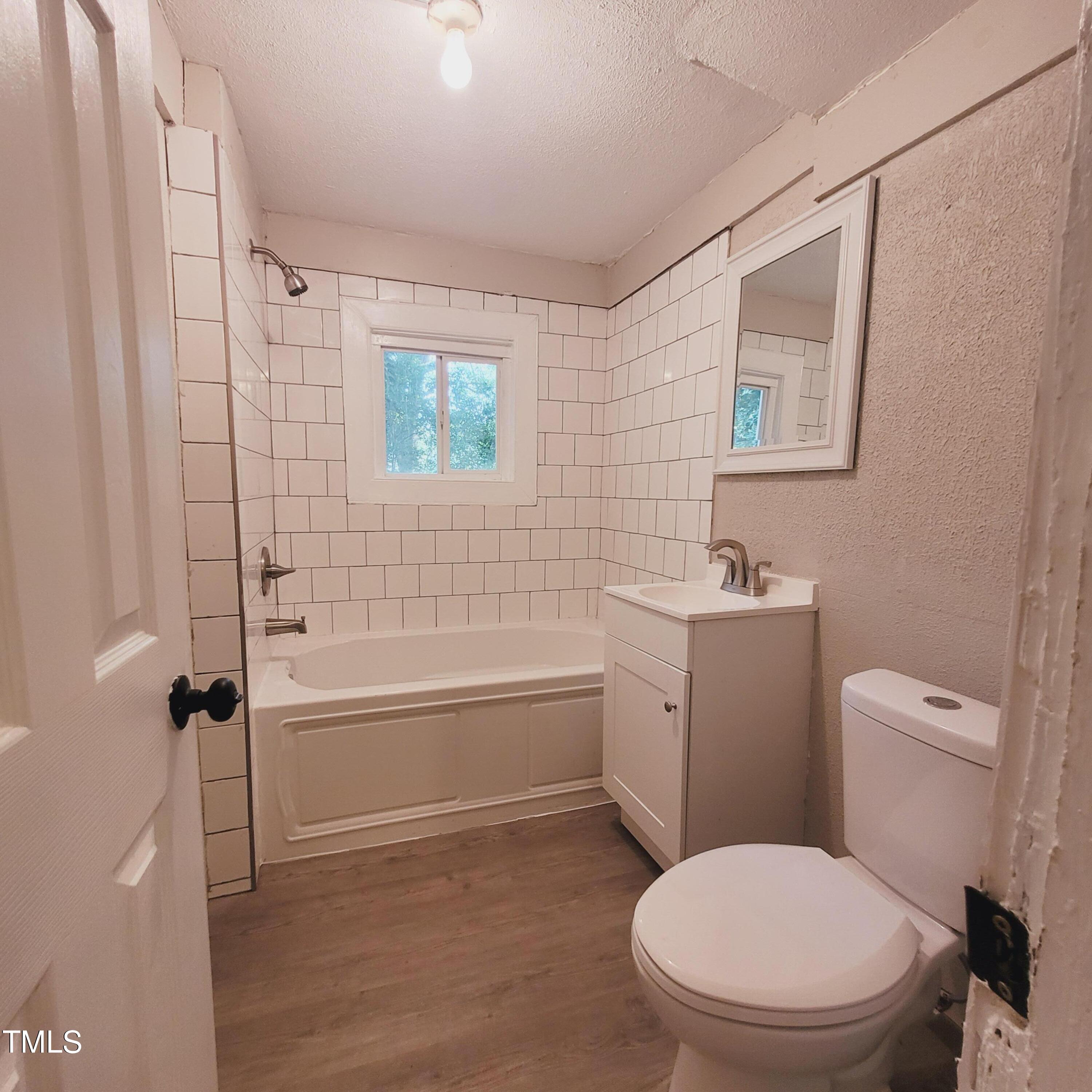 1615 Poole Road Raleigh, NC 27610 - Photo 8 of 14 a white toilet sitting next to a bath tub