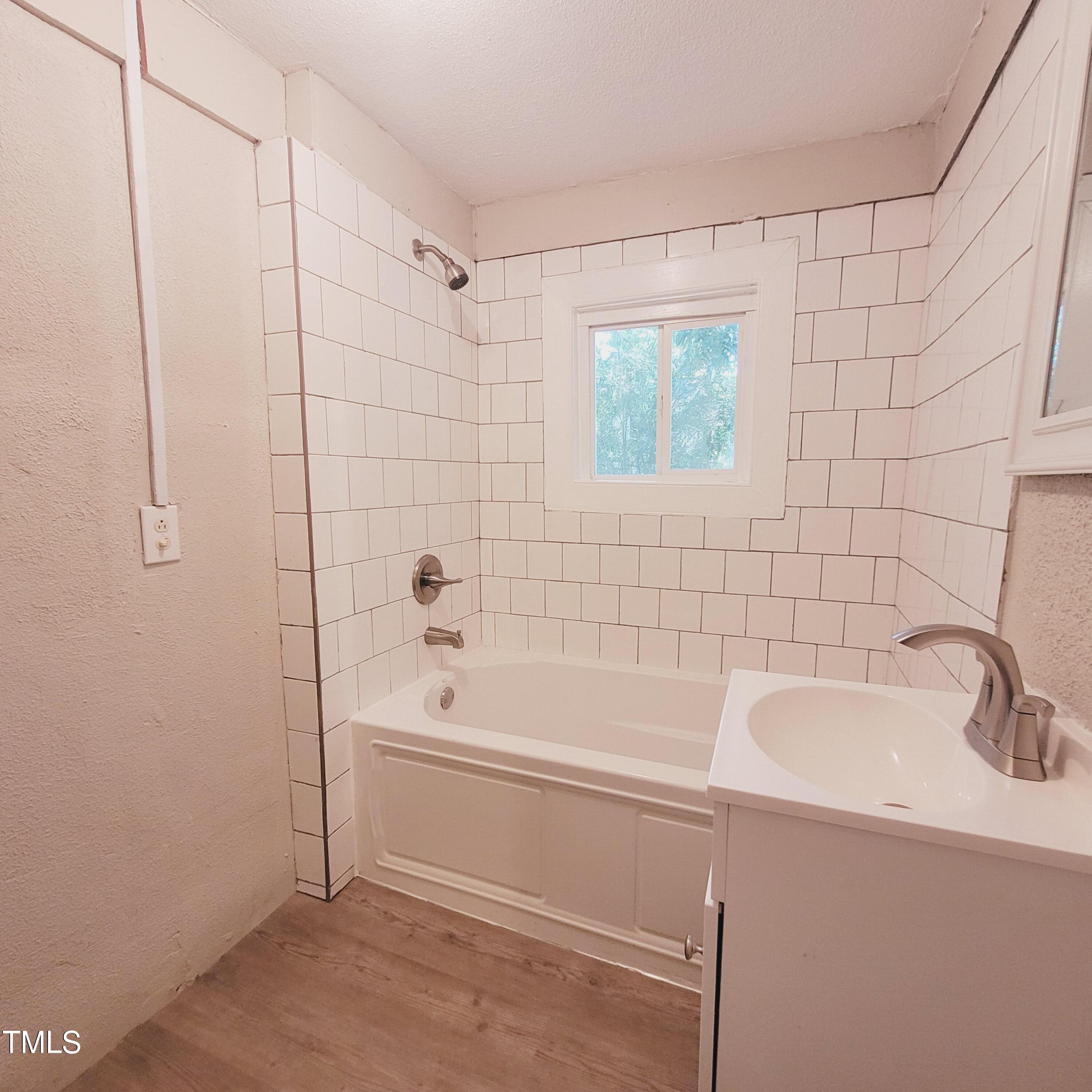 1615 Poole Road Raleigh, NC 27610 - Photo 9 of 14 a bathroom with a sink and a bathtub