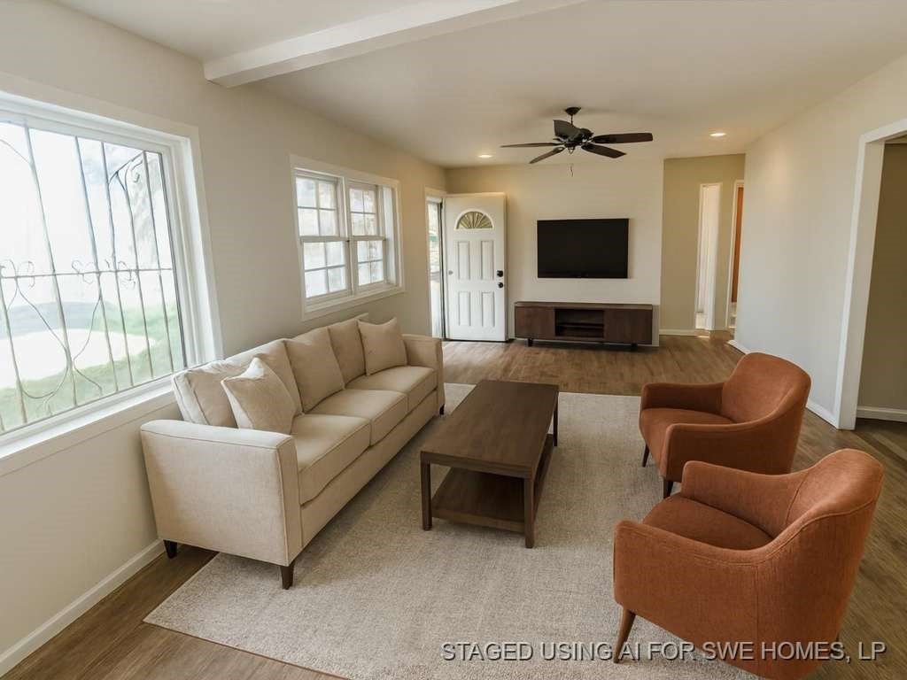 1909 Kokomo Street Plainview, TX 79072 - Photo 5 of 10 a living room with furniture and a flat screen tv