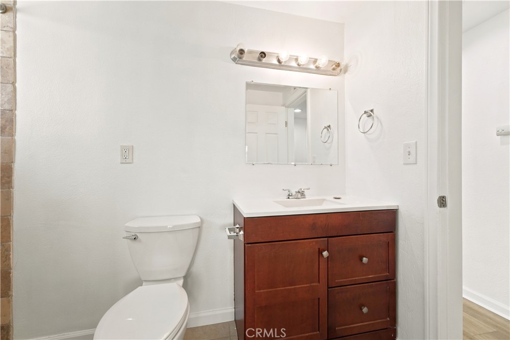 1720 Anderson Street Simi Valley, CA 93065 - Photo 21 of 30 a bathroom with a toilet sink vanity and mirror