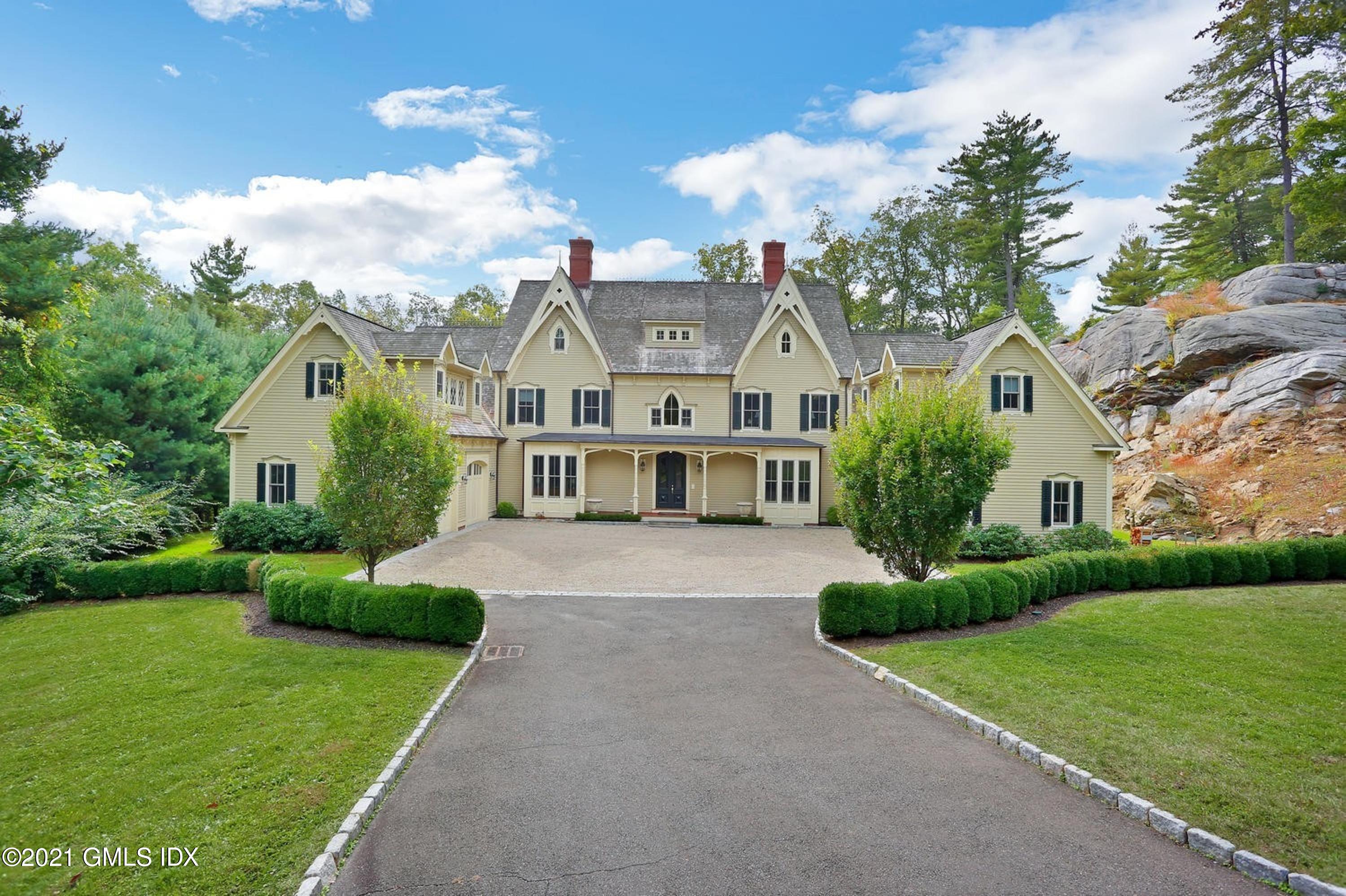 477 Riversville Road Greenwich, CT 06831 - Photo 1 of 33 a view of a house with a big yard plants and large trees