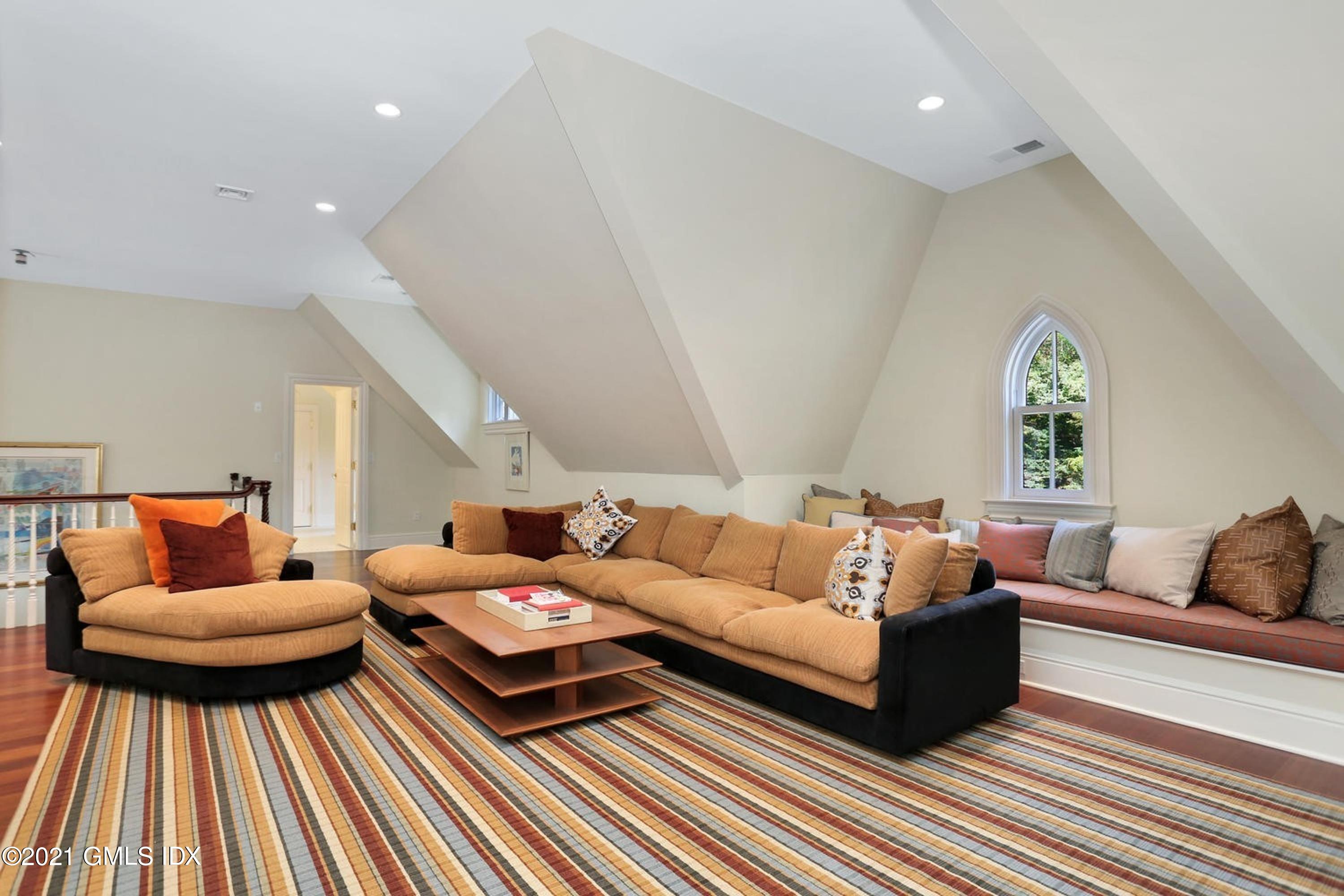 477 Riversville Road Greenwich, CT 06831 - Photo 23 of 33 a living room with furniture and a couch