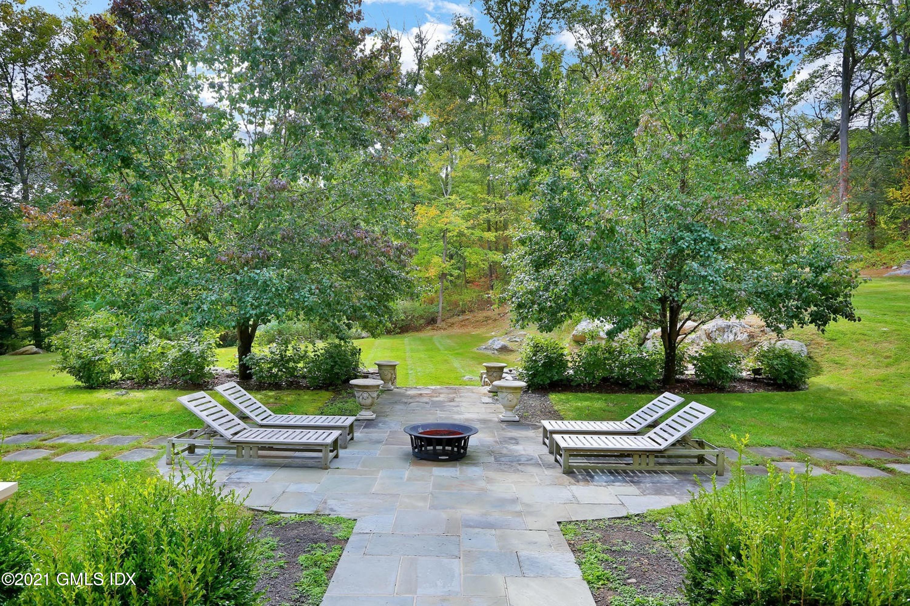 477 Riversville Road Greenwich, CT 06831 - Photo 27 of 33 a view of a patio with a table and chairs