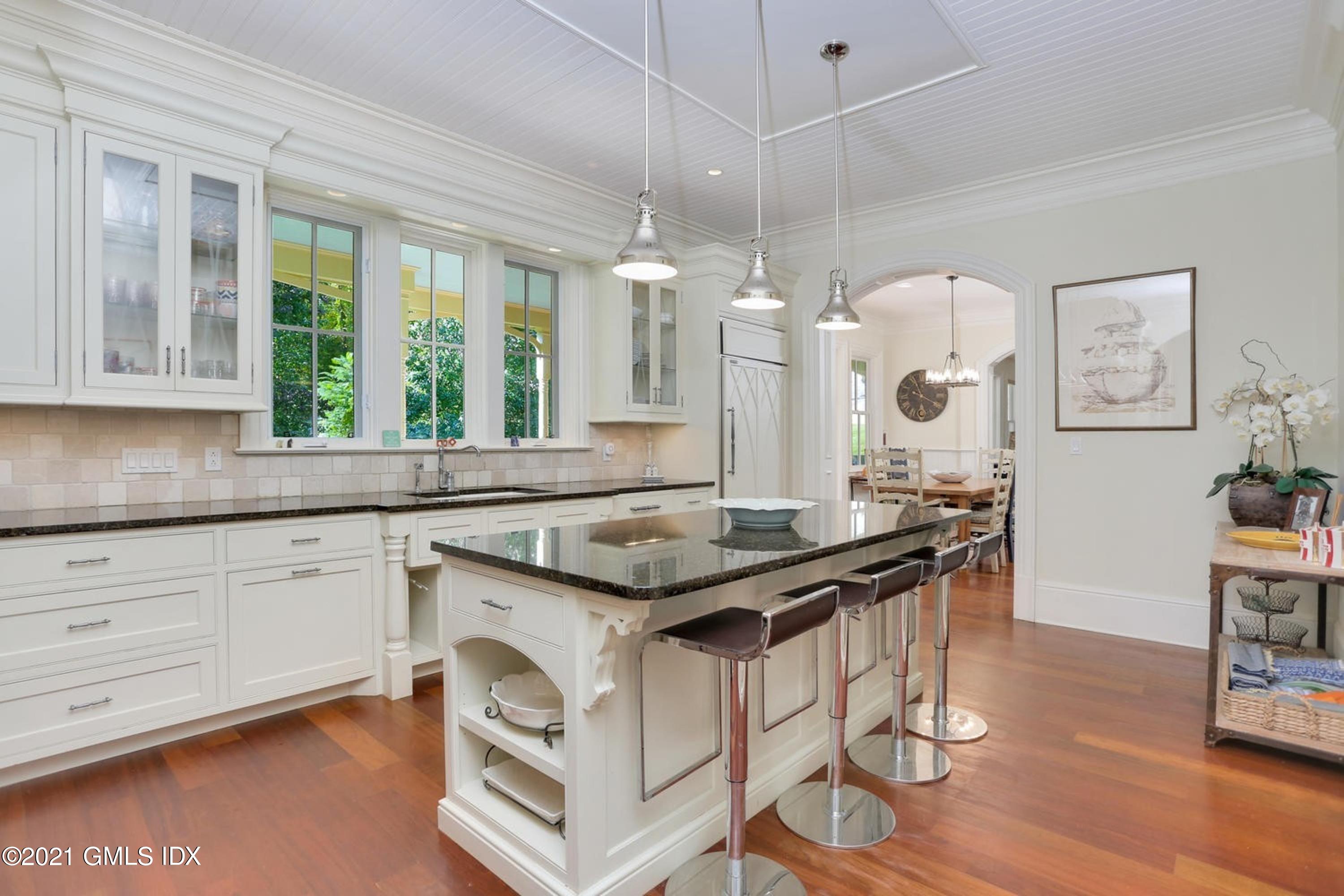 477 Riversville Road Greenwich, CT 06831 - Photo 10 of 33 a kitchen with granite countertop a sink cabinets and wooden floor