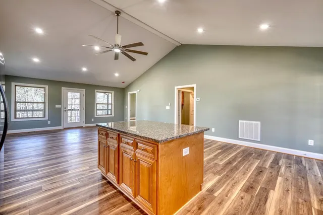 a spacious bathroom with a granite countertop sink a mirror and window