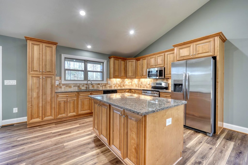 1323 John Smith Road East Blairsville, GA 30512 - Photo 9 of 34 a kitchen with stainless steel appliances granite countertop a refrigerator a sink a stove and island