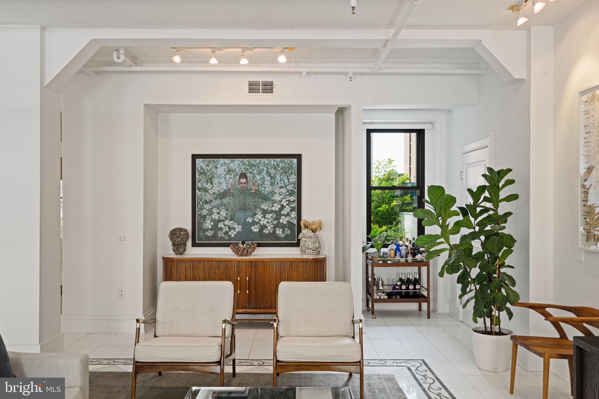 1920 Chestnut Street, Unit 5N Philadelphia, PA 19103 - Photo 13 of 33 a living room with furniture a potted plant and a fireplace