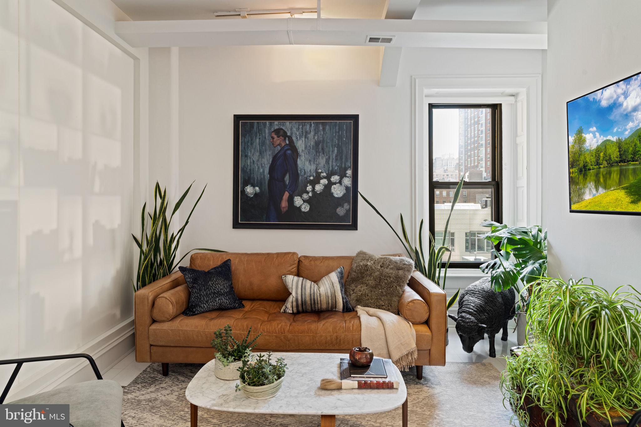 1920 Chestnut Street, Unit 5N Philadelphia, PA 19103 - Photo 16 of 33 a living room with furniture plant and a window