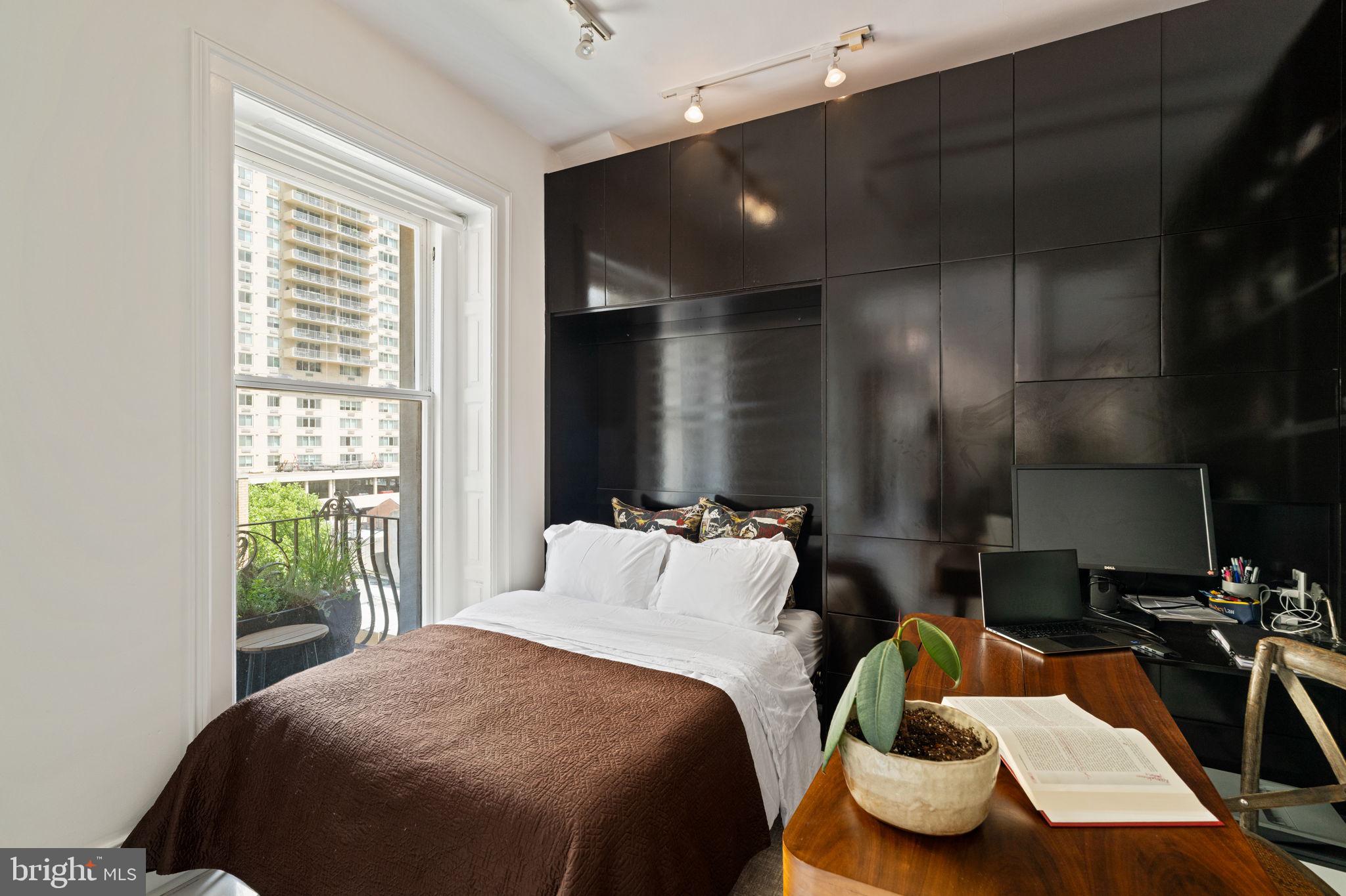 1920 Chestnut Street, Unit 5N Philadelphia, PA 19103 - Photo 18 of 33 a bedroom with bed and a large window