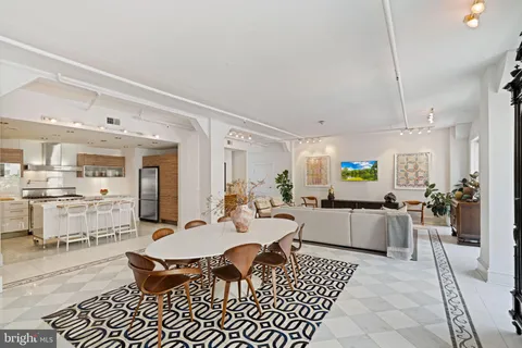 a large kitchen with a table and chairs