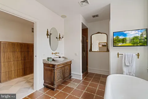 a bathroom with a sink a toilet and mirror