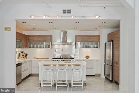 a kitchen with cabinets and chairs in it