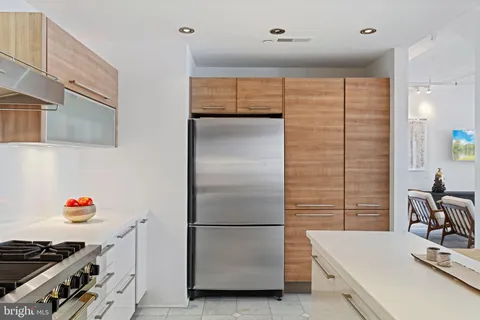 a kitchen with a refrigerator and a sink