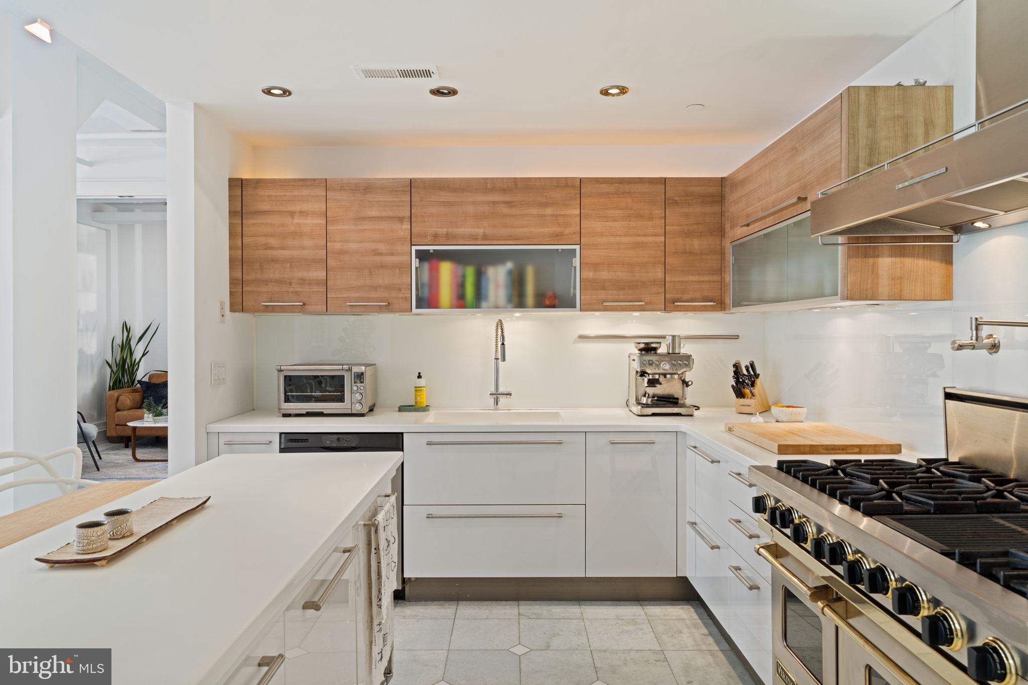 1920 Chestnut Street, Unit 5N Philadelphia, PA 19103 - Photo 7 of 33 a kitchen with stainless steel appliances a sink stove and cabinets