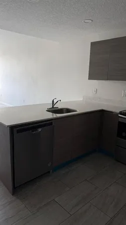 a kitchen with a sink and cabinets