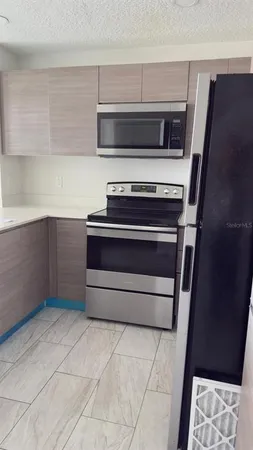 a stove top oven sitting inside of a kitchen