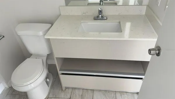 a bathroom with a toilet and a sink