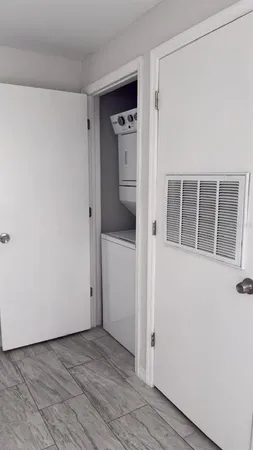 a view of empty room with wooden floor and cabinet