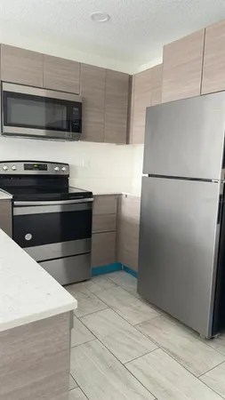 a kitchen with a refrigerator and a stove