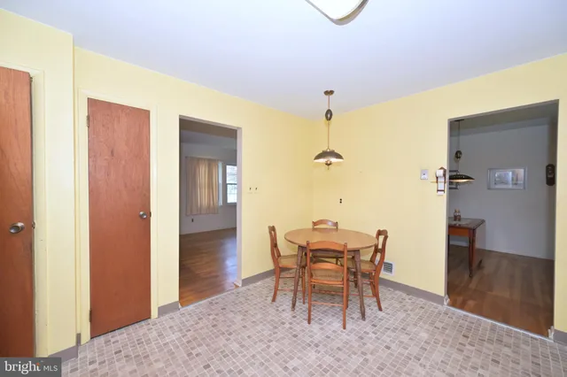 a dining room with furniture and a window
