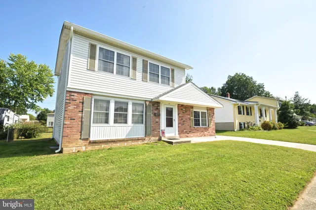 a front view of a house with a yard table and chairs