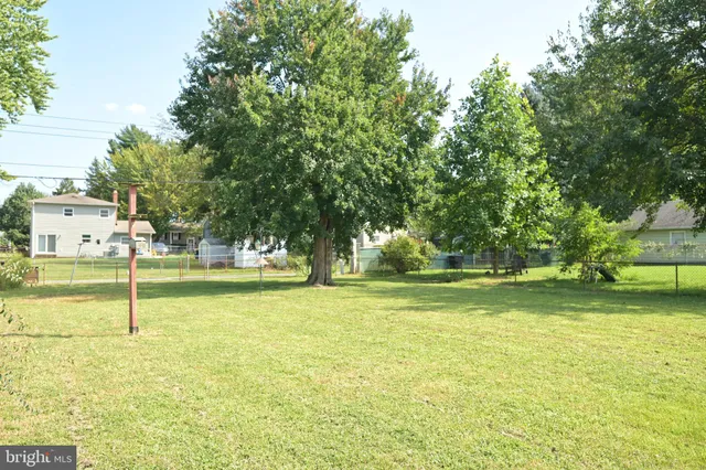 a swimming pool with an outdoor space and seating area