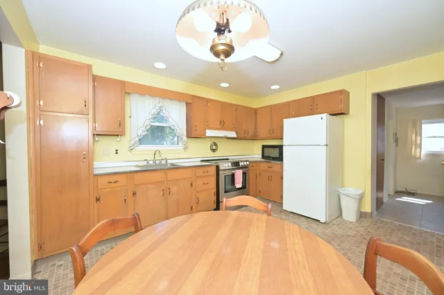 a kitchen with refrigerator a sink and cabinets
