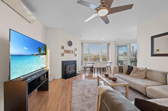 a living room with furniture flat screen tv and a fireplace