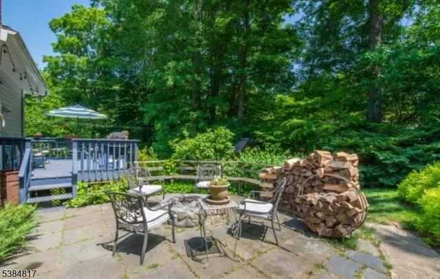 a view of a chairs and table in backyard