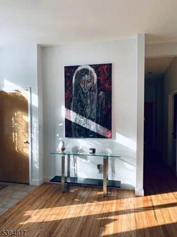 a view of a bedroom with wooden floor and windows