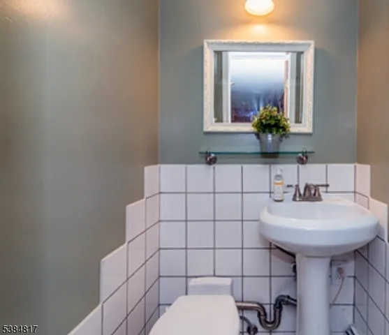 a bathroom with a sink toilet and mirror