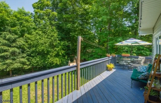 a view of balcony with furniture and umbrella