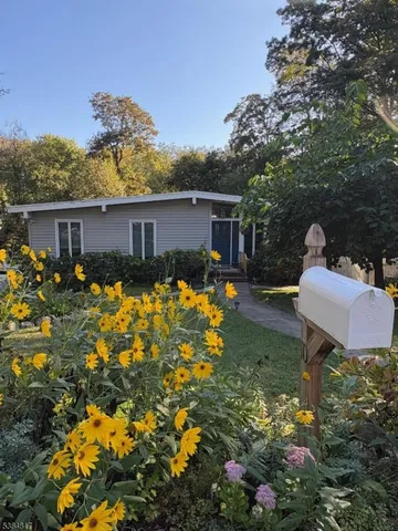 a backyard of a house with yard table and chairs