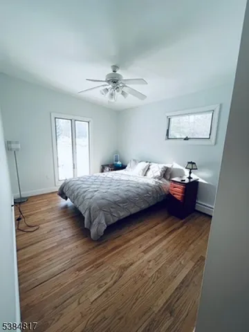 a bedroom with a bed and a ceiling fan