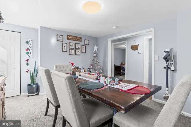 a view of a dining room with furniture and a table